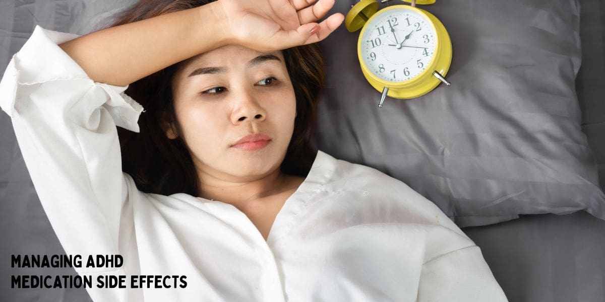 Woman lying awake in bed with alarm clock nearby representing sleep issue caused by adhd medication side effect